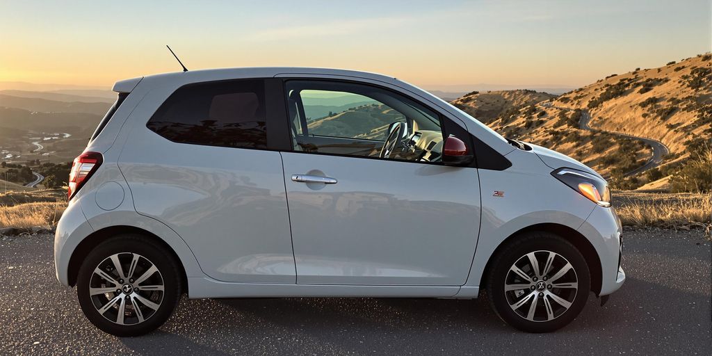 Compact car parked on scenic, affordable road trip.