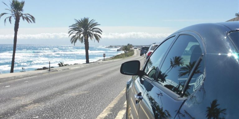 Car parked near ocean for long-term rental.