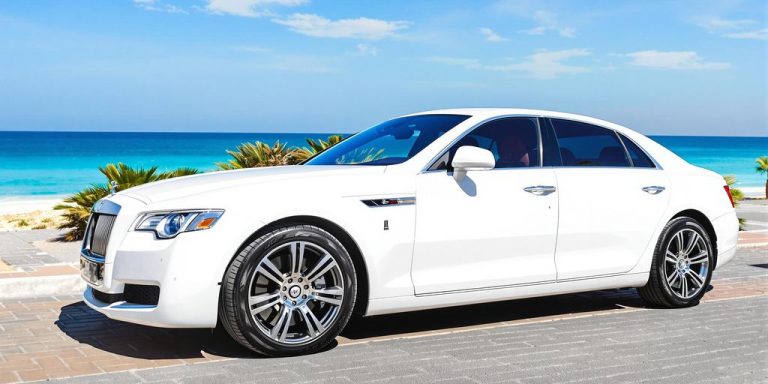 Luxury car parked by beach in Ajman.